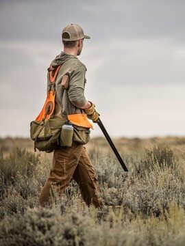 Hunter walking through scrubland at DPWR